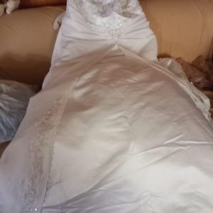 This is a brand new wedding dress for sale with the veil and shoes